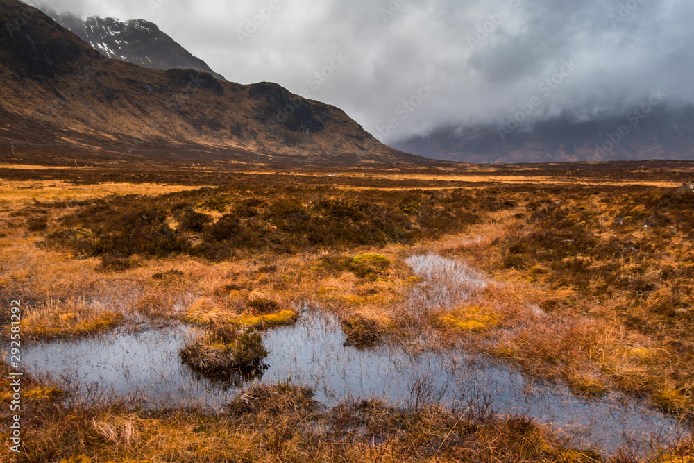 Marshes in the valley near Buachaille Etive Mor on a moody day, Glencoe, Scotland Marshes in the valley near Buachaille Etive Mor on a moody day, Glencoe, Scotland