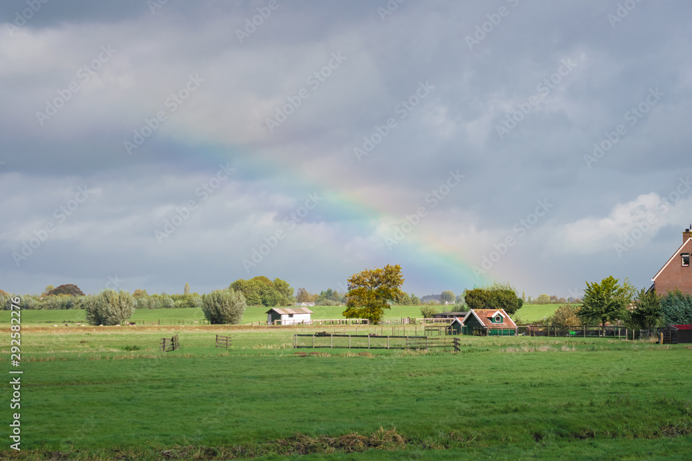Beautiful colors of a rainbow over traditional polder landscape in Holland Beautiful colors of a rainbow over traditional polder landscape in Holland