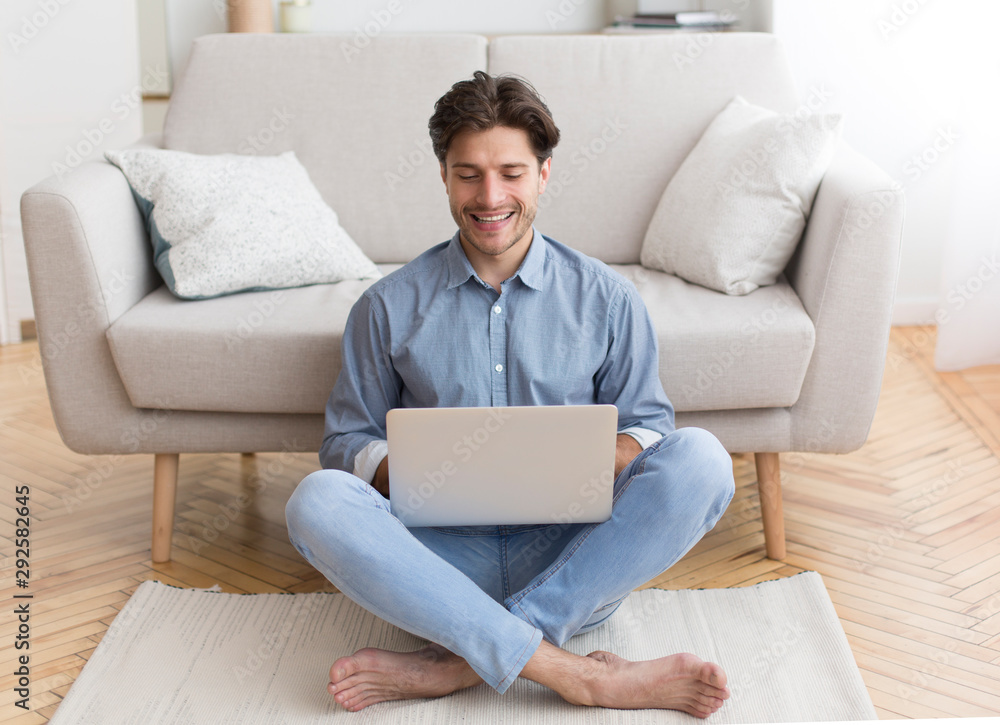 Successful Freelancer Working On Laptop Sitting On Floor At Home Successful Freelancer Working On Laptop Sitting On Floor At Home