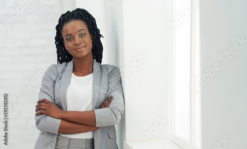 Young Black Lady Looking At Camera Standing In Office