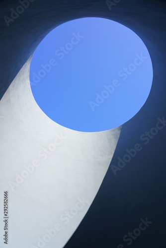 Hole in a roof letting in light and the blue sky