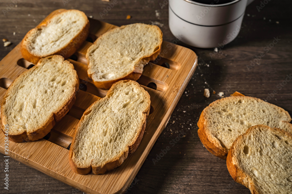 bread for breakfast, with cup of coffee over rustic wooden background with copy space. Morning breakfast with coffee and toasts. bread for breakfast, with cup of coffee over rustic wooden background with copy space. Morning breakfast with coffee and toasts.