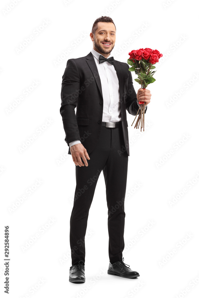 Man in a suit holding a bunch of red roses Man in a suit holding a bunch of red roses