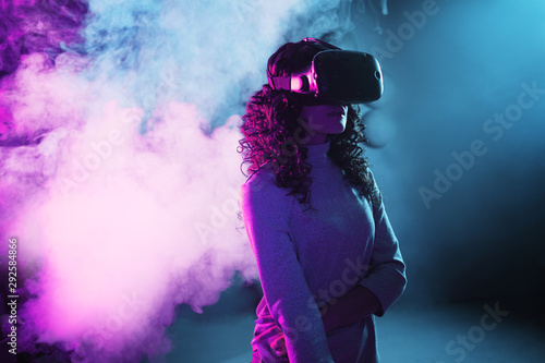 Virtual reality game. A girl in a VR helmet plays a game or explores the environment.