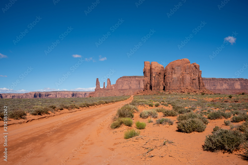 Road Leading to the Three Sisters Rock Formation in Monument Valley, Arizona