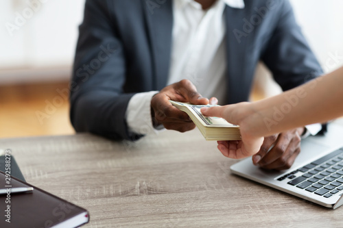 Photography Unrecognizable black businessman accepting bribe from client, sealing the deal