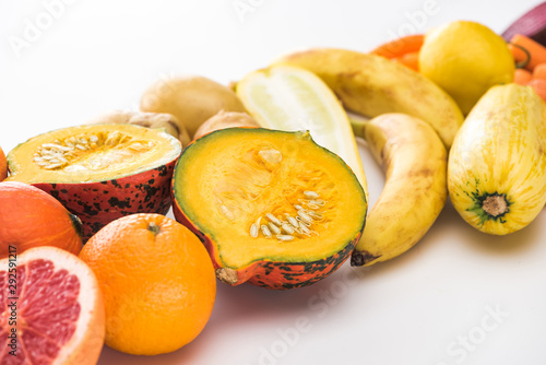 oranges, pumpkin, bananas, zucchini, lemon on white background