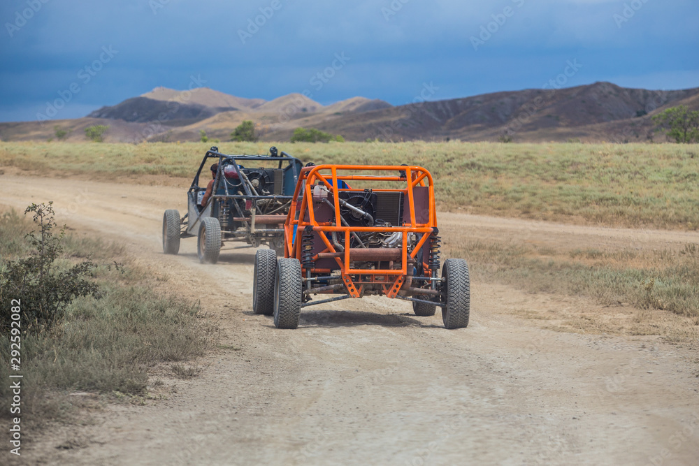 Buggy moves on a dirt dusty road