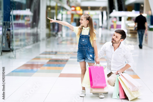 Girl Pointing Finger During Shopping With Father In Mall