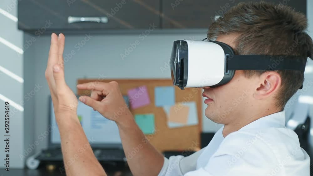 Handsome Businessman With VR Headset Working On a Virtual Business Report. Interactive Business Working Concept Handsome Businessman With VR Headset Working On a Virtual Business Report. Interactive Business Working Concept