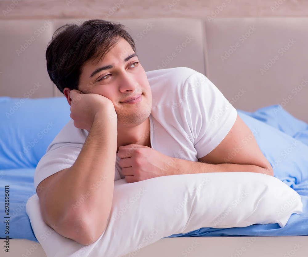 Man suffering from insomnia lying in bed Man suffering from insomnia lying in bed