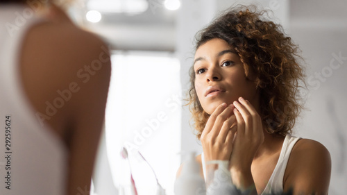 Black Millennial Girl Looking At Pimple In Bathroom, Panorama photo