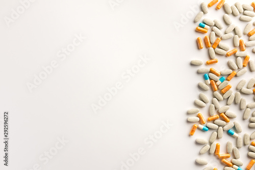 Pills scattered on white background. Flat lay.