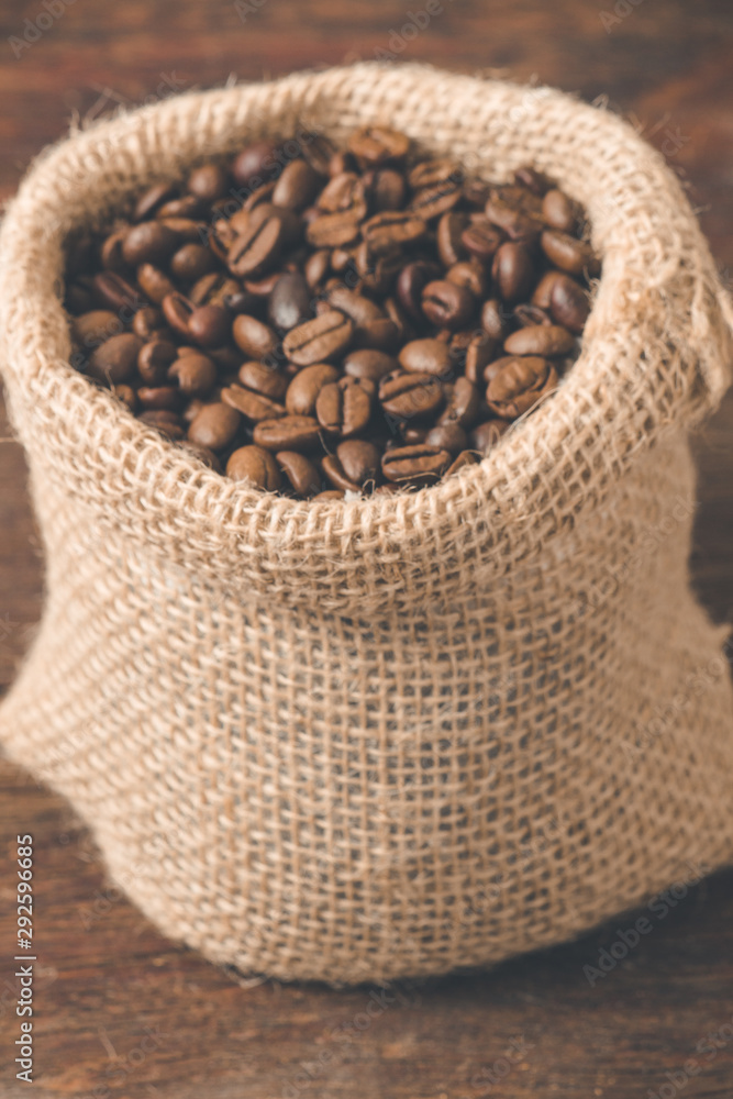 Cup of coffee with some cookies and coffee beans in jute sack.. Cup of coffee with some cookies and coffee beans in jute sack..