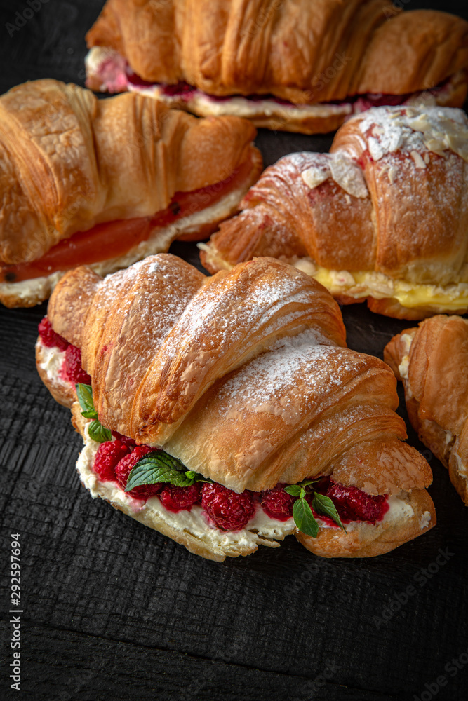 A lot of Croissants sandwich with boiled chicken, mushrooms, cheese, tomatoes, and different toppings. Healthy, tasty, nourishing snack. Take away food