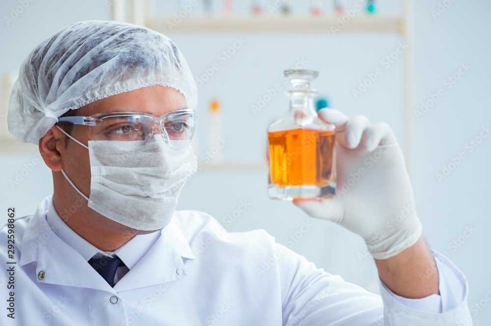 Chemist mixing perfumes in the lab Chemist mixing perfumes in the lab