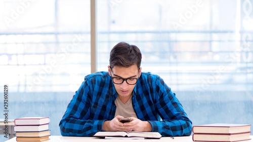 Student studying in the empty library with book preparing for ex photo