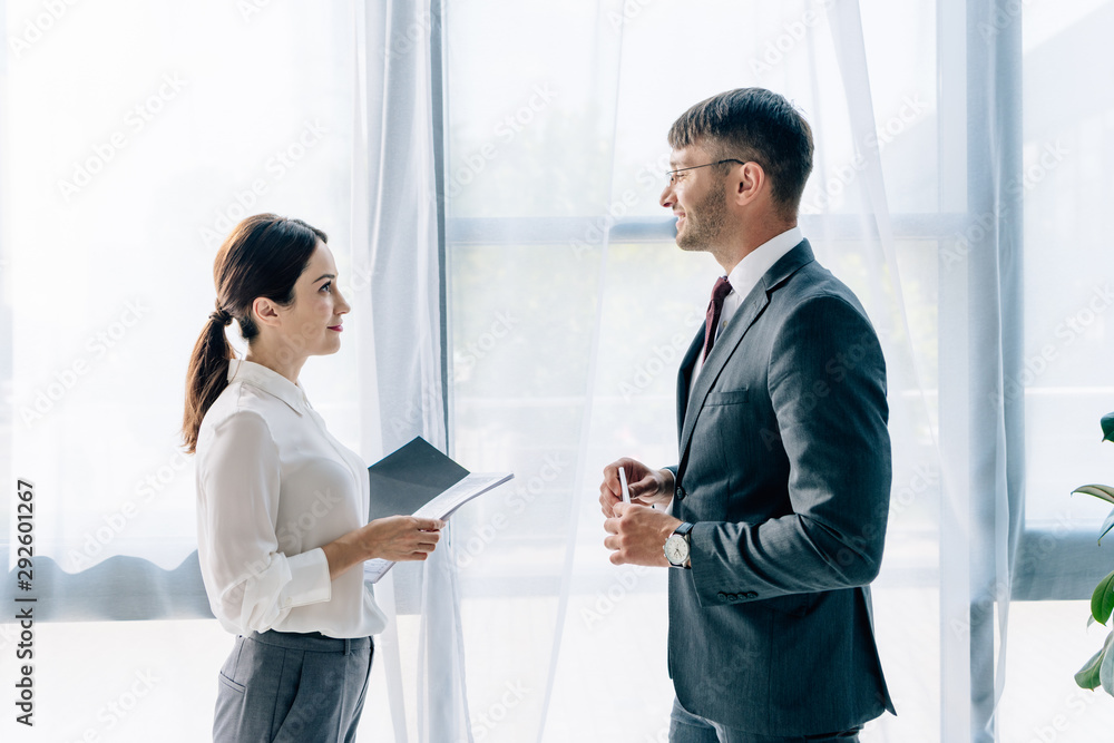 side view of journalist talking with businessman in formal wear side view of journalist talking with businessman in formal wear