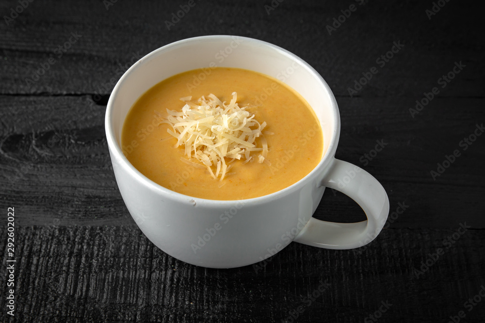 Cream soup made of pumpkin, spinach, broccoli and lentils with parmesan, pumpkin seeds and cream. Tasty, healthy nutritious lunch. Cream soup made of pumpkin, spinach, broccoli and lentils with parmesan, pumpkin seeds and cream. Tasty, healthy nutritious lunch.