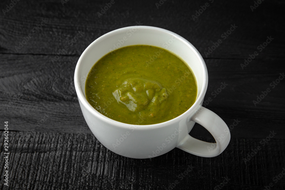 Cream soup made of pumpkin, spinach, broccoli and lentils with parmesan, pumpkin seeds and cream. Tasty, healthy nutritious lunch. Cream soup made of pumpkin, spinach, broccoli and lentils with parmesan, pumpkin seeds and cream. Tasty, healthy nutritious lunch.