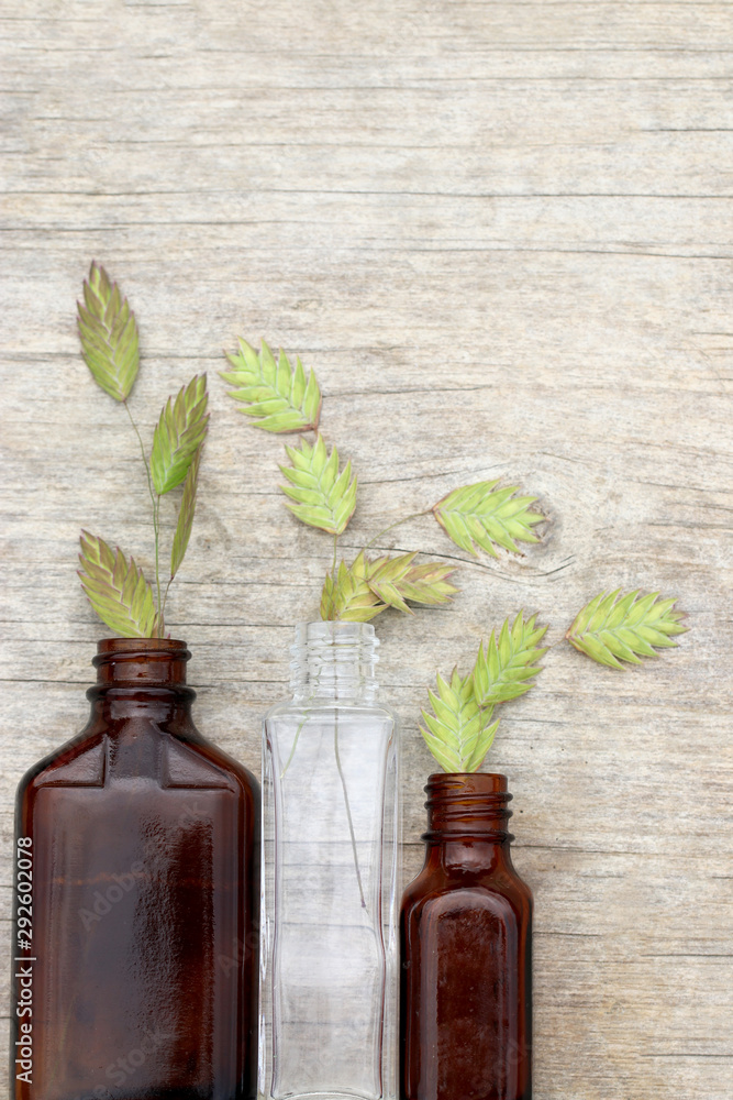 Vertical flat lay (background) of small glass bottles holding the