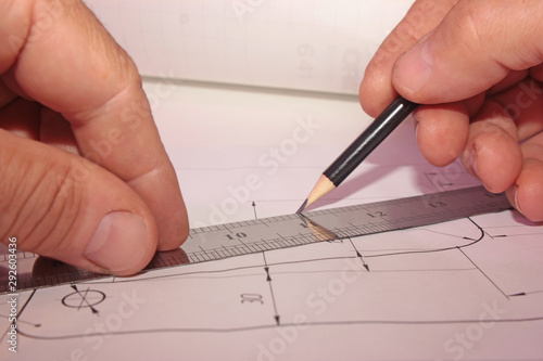 drawing and work, ruler and pencil in the hands of an engineer at the workplace, workplace concept on the technical drawing, structure and construction