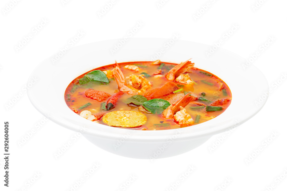 Closeup plate of traditional thai soup - tom yum kung isolated at white background.