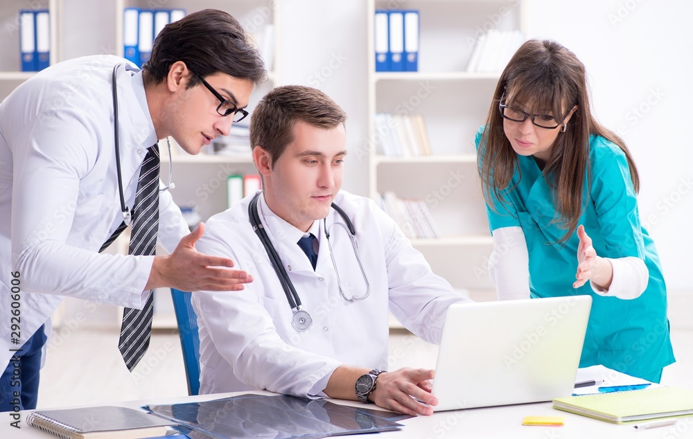 © Elnur - The three doctors discussing scan results of x-ray image