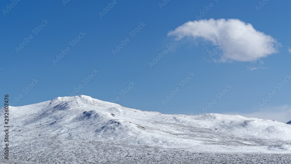White clouds floating over snow mountains with blue sky background, beautiful landscape of China southwest.
