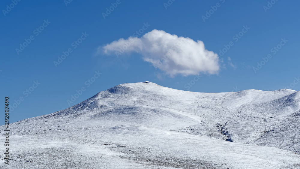 White clouds floating over snow mountains with blue sky background, beautiful landscape of China southwest.