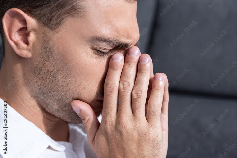 depressed man crying in living room at home depressed man crying in living room at home