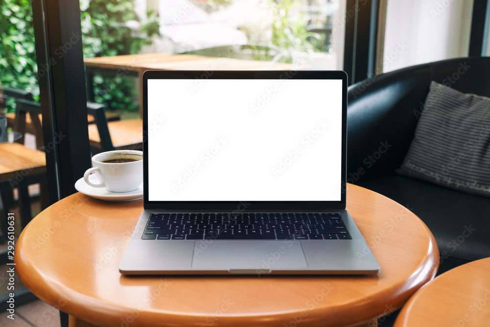 Mockup image of laptop computer with blank white desktop screen on wooden table Mockup image of laptop computer with blank white desktop screen on wooden table