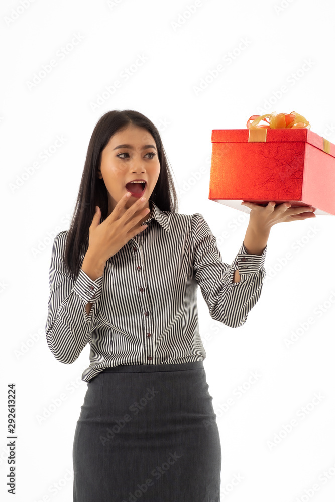 Portrait of business woman looking to the gift.Asian young lady holding beautiful red present box with surprise facial expression isolated on white background. Portrait of business woman looking to the gift.Asian young lady holding beautiful red present box with surprise facial expression isolated on white background.