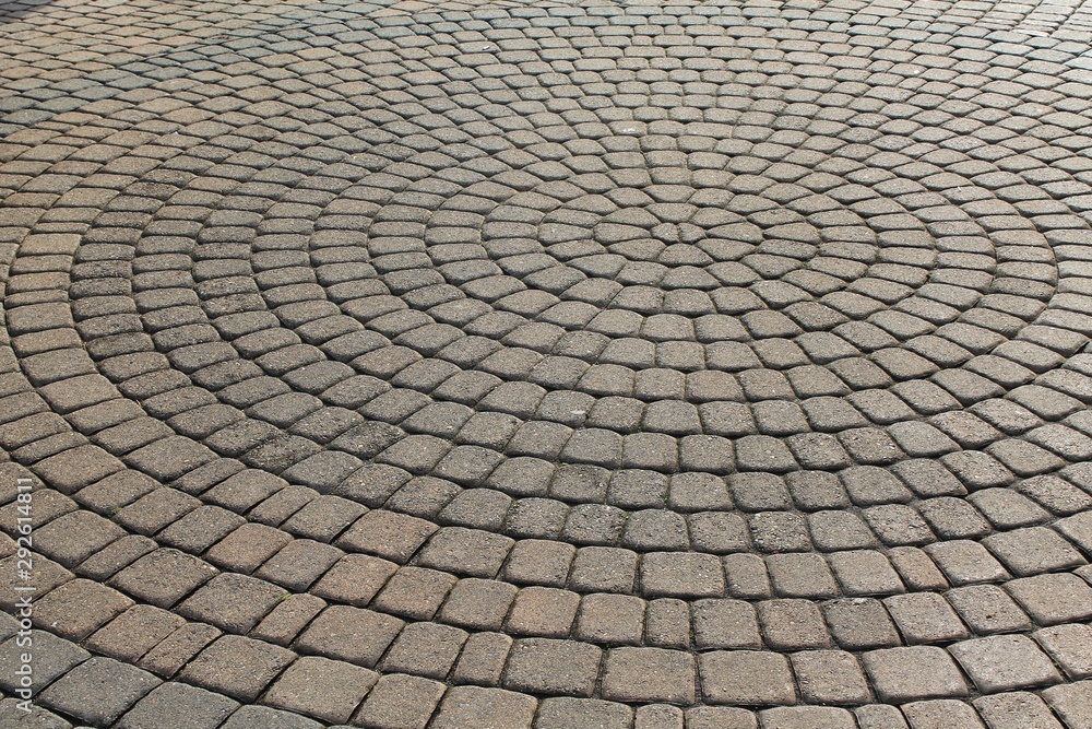 Brown stone pavers set in concentric circles and tilted askew