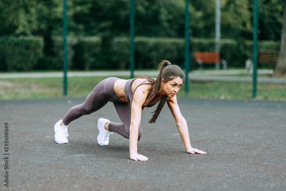 Push-UPS, workout and plank on the street. Beautiful athletic girl on the Playground. Push-UPS, workout and plank on the street.
