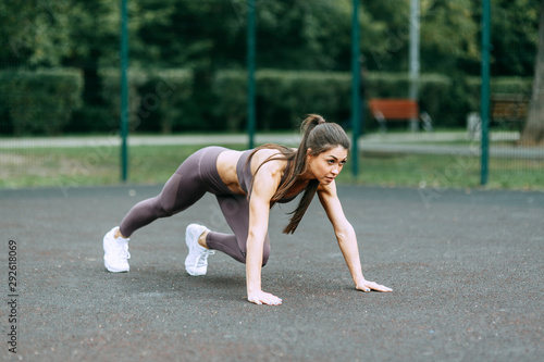 Push-UPS, workout and plank on the street. Beautiful athletic girl on the Playground. Push-UPS, workout and plank on the street.