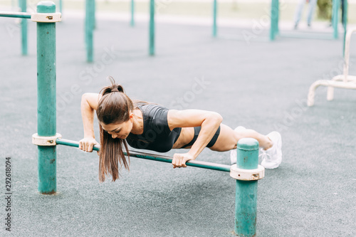 Push-UPS, workout and plank on the street. Beautiful athletic girl on the Playground. Push-UPS, workout and plank on the street.