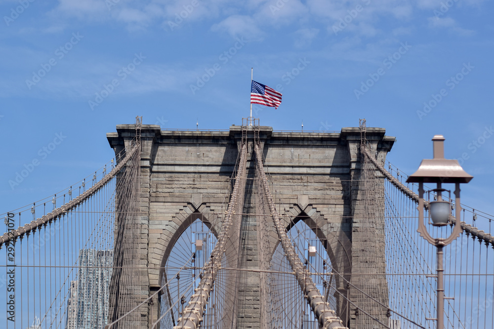 Fototapeta premium American flag on Brooklin Bridge, New York, USA