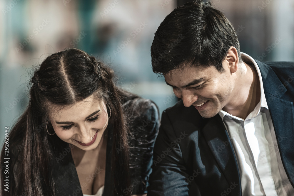 business couple working on tablet in modern office.Handsome and Confident Businessman Using Laptop Computer and Technology Gadget Smartphone outdoor Discussing With Beautiful Business Partner . business couple working on tablet in modern office.Handsome and Confident Businessman Using Laptop Computer and Technology Gadget Smartphone outdoor Discussing With Beautiful Business Partner .