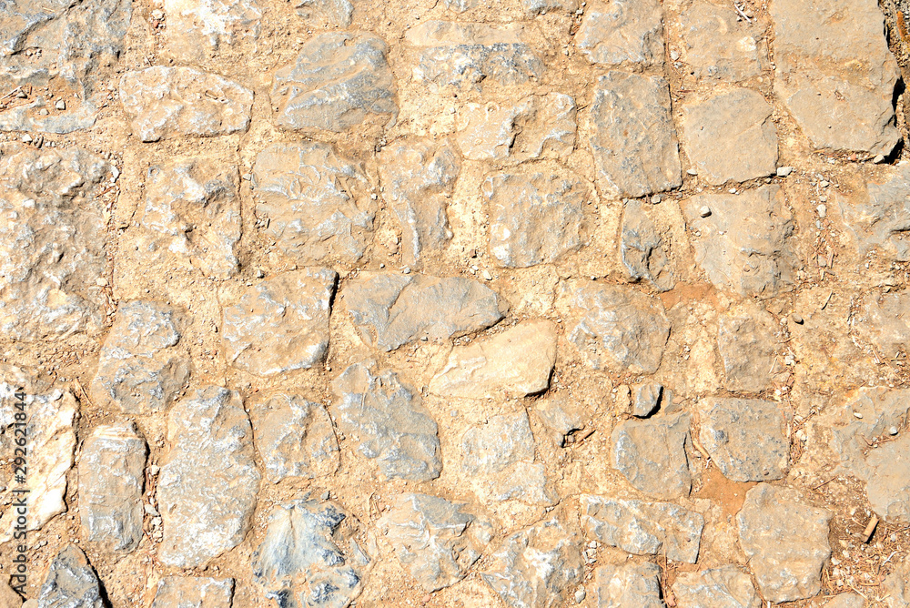 Old stone footpath close up. Abstract background Old stone footpath close up. Abstract background