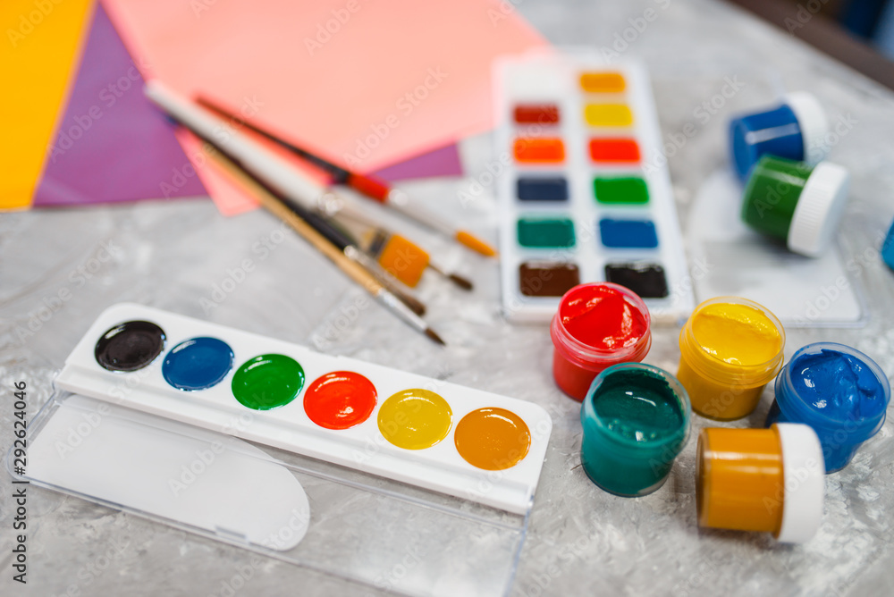 Fototapeta premium Watercolor paints on the table in stationery store