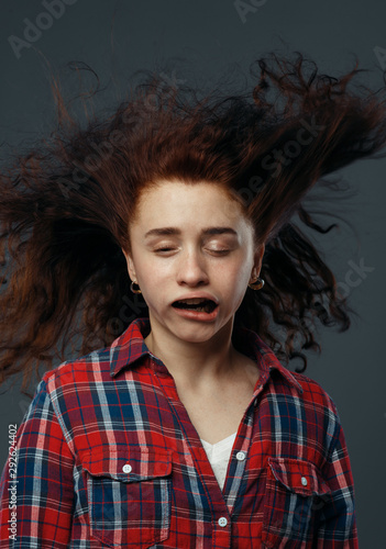 Obraz na płótnie Strong wind blowing on woman's face, funny emotion