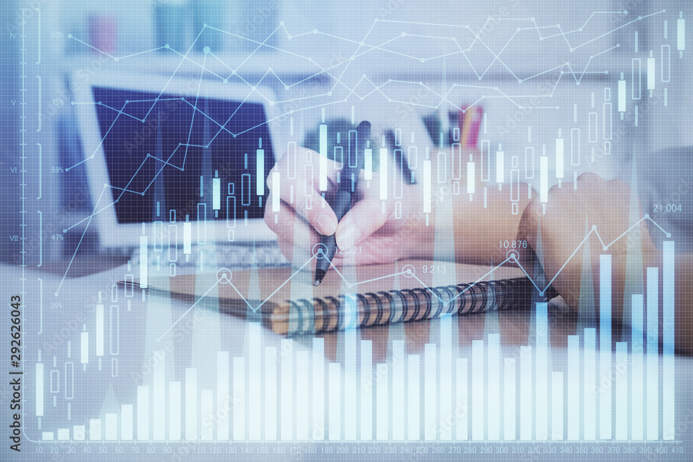 Financial graph displayed on woman's hand taking notes background. Concept of research. Double exposure Financial graph displayed on woman's hand taking notes background. Concept of research. Double exposure