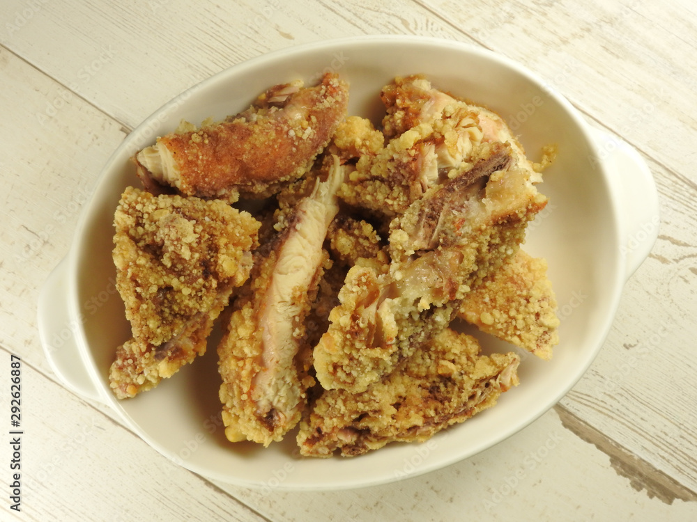 Top view of a plate of fried chicken cutlet (also call fried chicken chop) on wooden background. Taiwan night market food. Fried chicken cutlets is Taiwanese specialty. With copy space. Top view of a plate of fried chicken cutlet (also call fried chicken chop) on wooden background. Taiwan night market food. Fried chicken cutlets is Taiwanese specialty. With copy space.