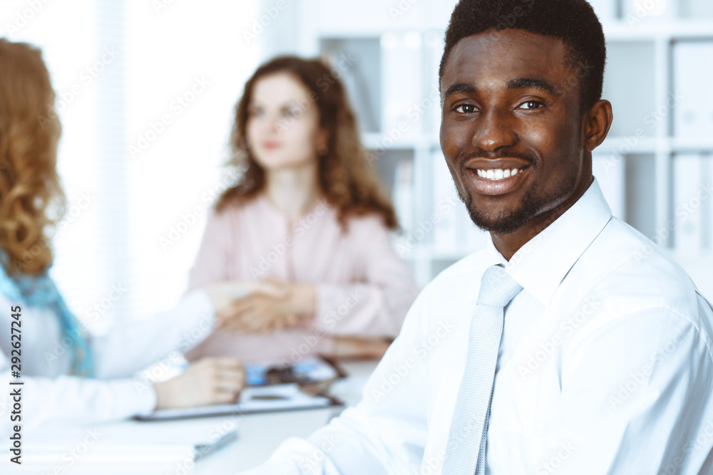 African american businessman at meeting in office, colored in white. Multi ethnic business people group African american businessman at meeting in office, colored in white. Multi ethnic business people group