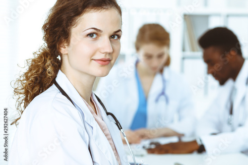 Happy doctor woman with medical staff at the hospital. Multi ethnic people group