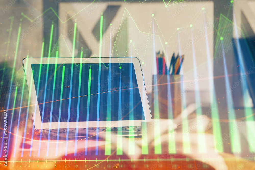 Financial market graph hologram and personal computer on background. Double exposure. Concept of forex. Financial market graph hologram and personal computer on background. Double exposure. Concept of forex.