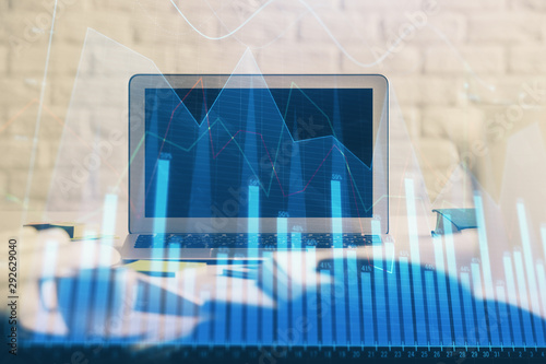 Forex market chart hologram and personal computer background. Double exposure. Concept of investment. © peshkova