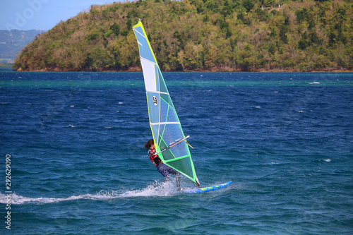 Young woman in sun protection clothes windsurfing (Trois Ilets, Martinique)