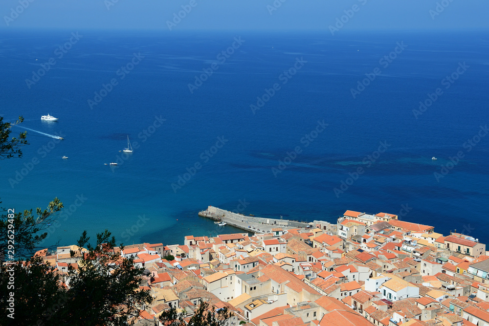 Naklejka premium View of Cefalu town from the rock of Rocca di Cefalu in the morning. Sicily, Italy